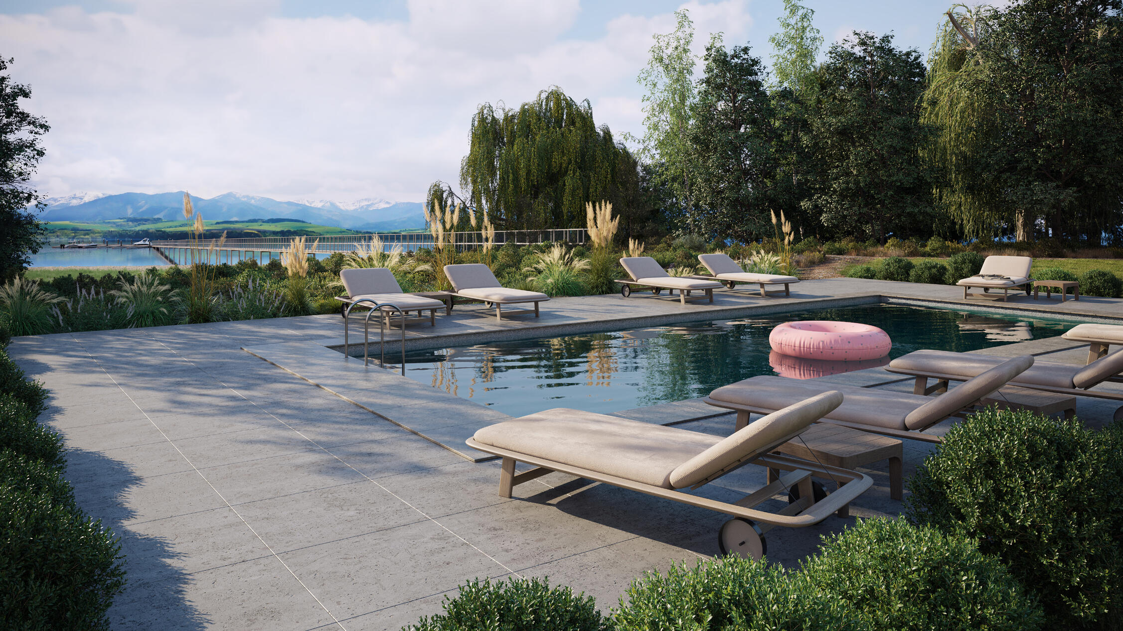 Lakeside pool with lounge chairs and mountain views